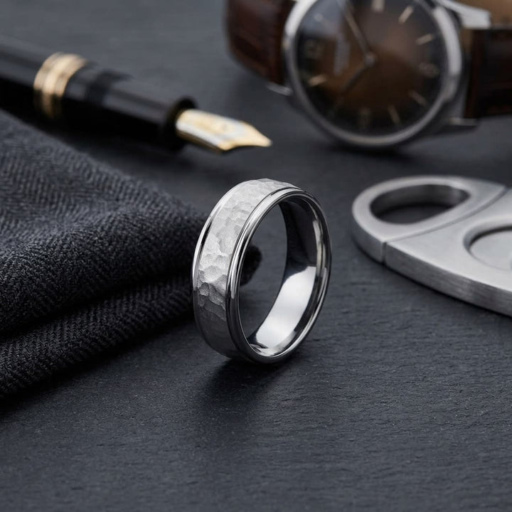 6mm Hammered Finish Carved Wedding Band in 14K White Gold, on walnut surface with pocket square