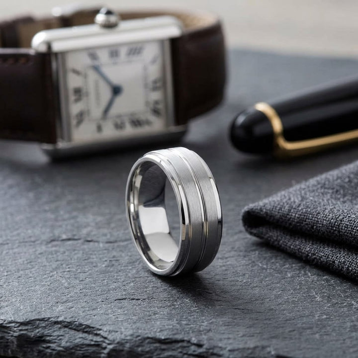 8mm Satin Finish High Polished Center Cut Carved Wedding Band in 14K White Gold, on walnut surface with pocket square