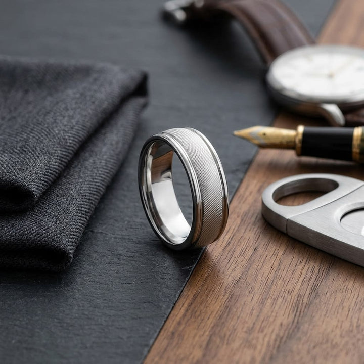 7mm Florentine Center High Polish Round Edge Carved Wedding Band in 14K White Gold, on walnut surface with pocket square