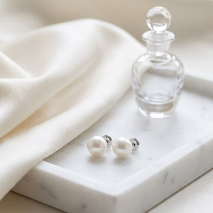 Cultured Pearl Pear Shape Stud Earrings in 14K White Gold, on marble vanity tray with silk