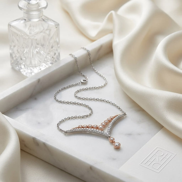 Diamond Pave And Prong Double Chevron Necklace In 14k White And Rose Gold, 16-18 Inch, on marble vanity tray with silk