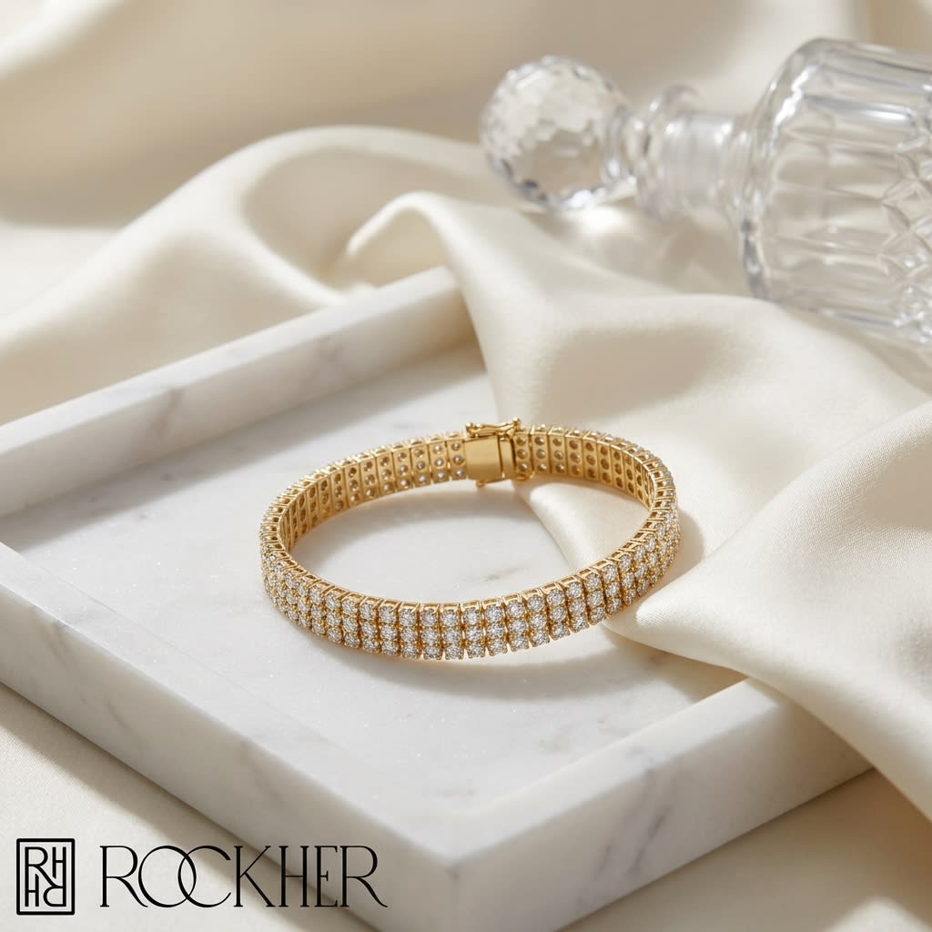 Diamond Round 4-prong Triple Row Bracelet in 14K Yellow Gold, on marble vanity tray with silk