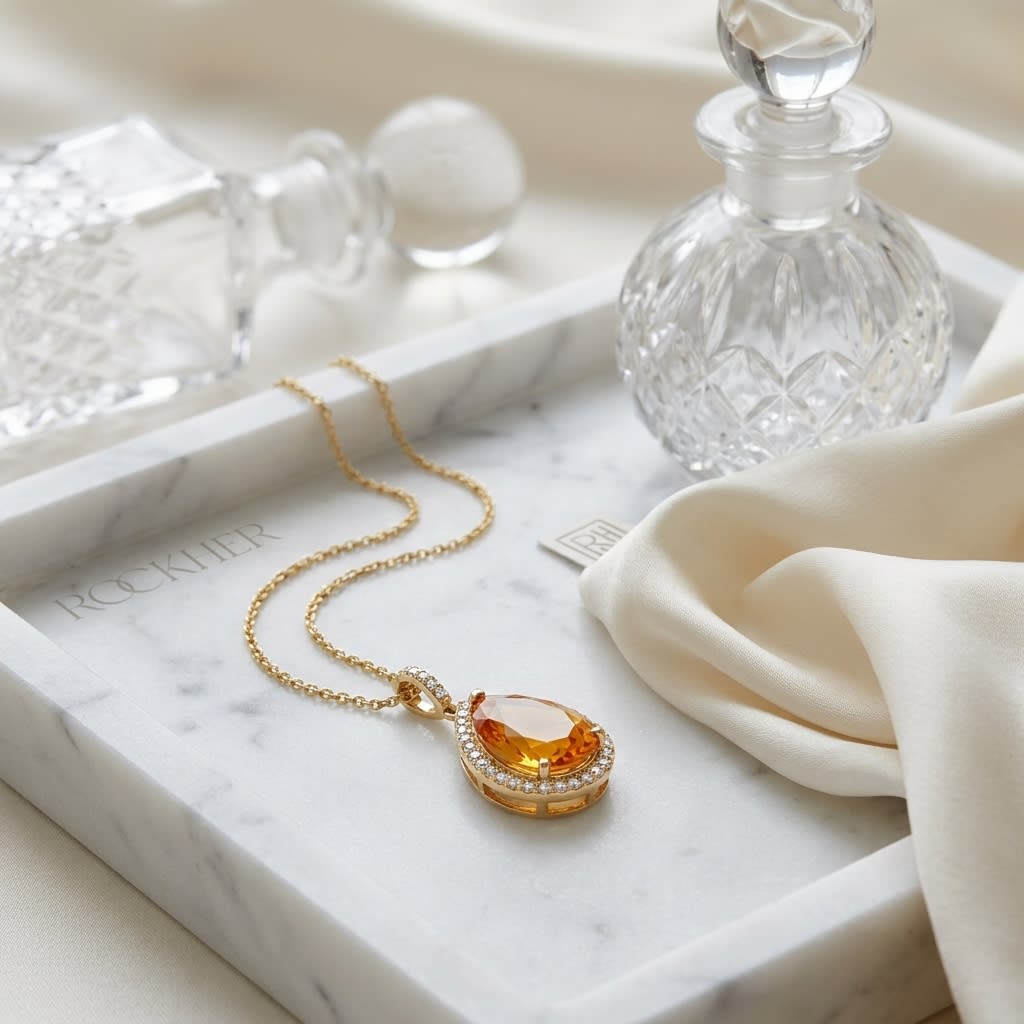 Citrine Pear Shape Halo Pendant in 14K Yellow Gold, on marble vanity tray with silk