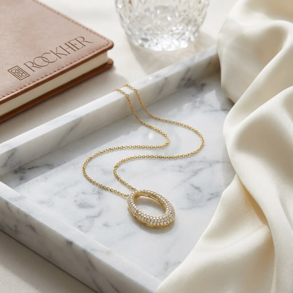 Natural Diamond Oval Pendant in 14K Yellow Gold, on marble vanity tray with silk