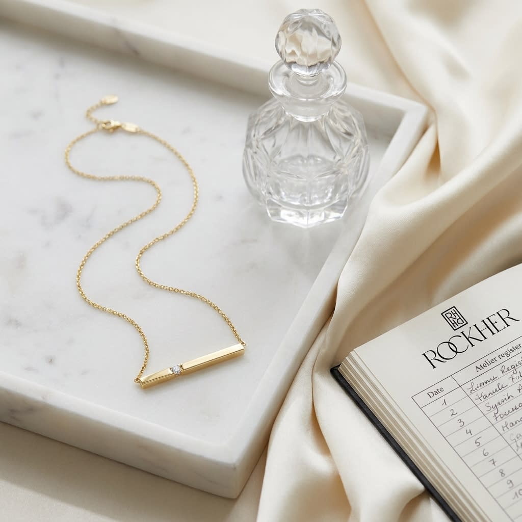 Diamond Bar Necklace in 14K Yellow Gold, on marble vanity tray with silk