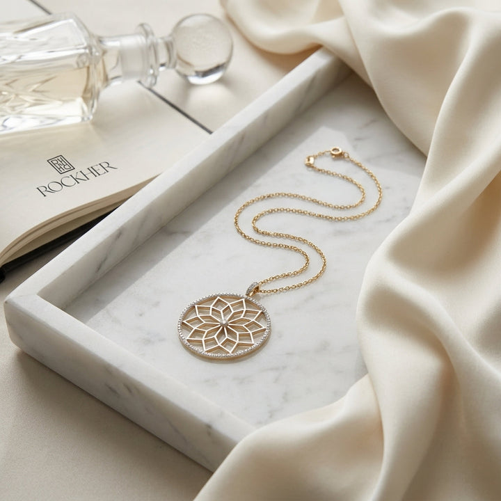 Diamond Snowflake Pendant With Circular Frame in 14k Yellow Gold 0.30ctw, 16-18 Inch Adjustable Rolo Chain, on marble vanity tray with silk