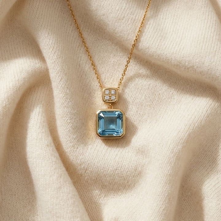 Swiss Blue Topaz Bezel Pendant 0.04ctw in 14K Yellow Gold - flat lay