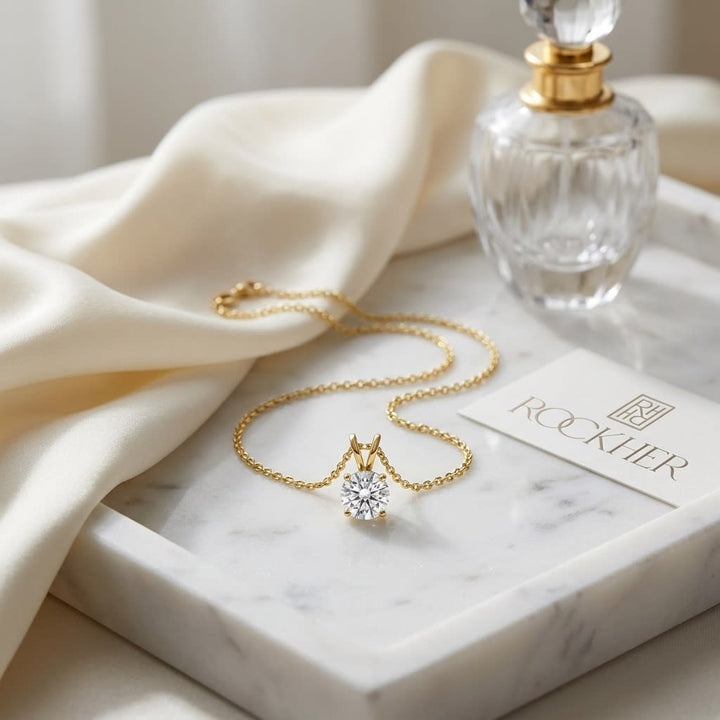 Natural Diamond Round Brilliant Solitaire Pendant in 14K Yellow Gold, 4 ct. t.w., on marble vanity tray with silk