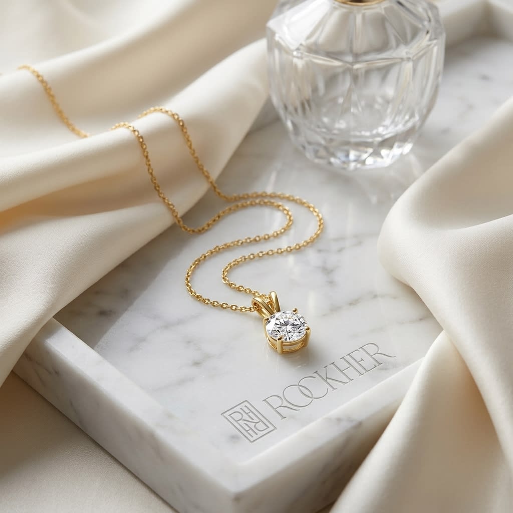 Natural Diamond Round Brilliant Solitaire Pendant in 14K Yellow Gold, 1 ct. t.w., on marble vanity tray with silk
