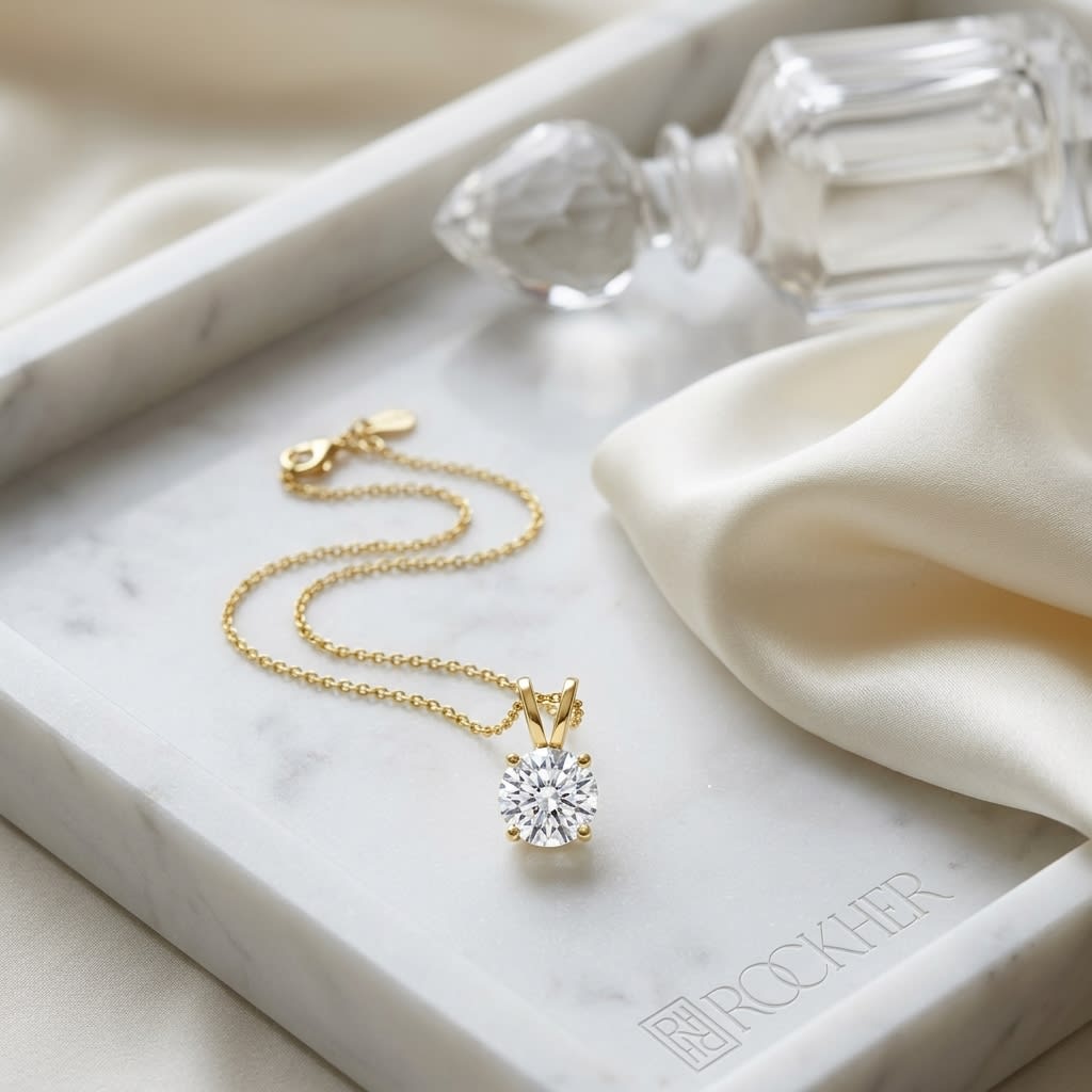 Natural Diamond Round Brilliant Solitaire Pendant in 14K Yellow Gold, 2 ct. t.w., on marble vanity tray with silk
