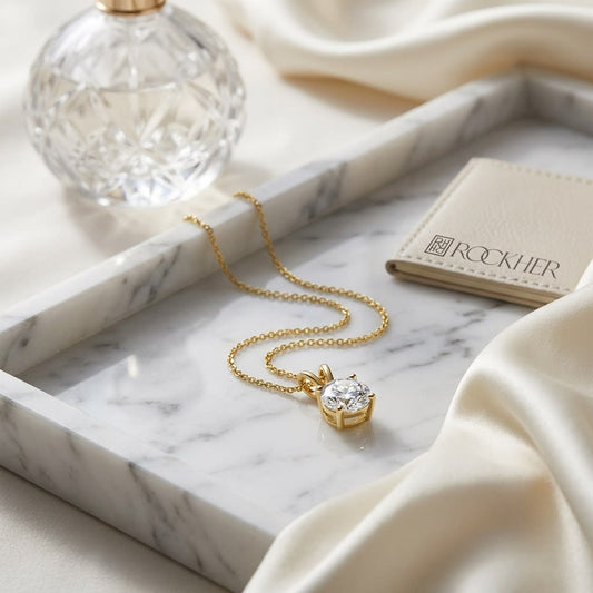 Natural Diamond Round Brilliant Solitaire Pendant in 14K Yellow Gold, 4 ct. t.w., on marble vanity tray with silk
