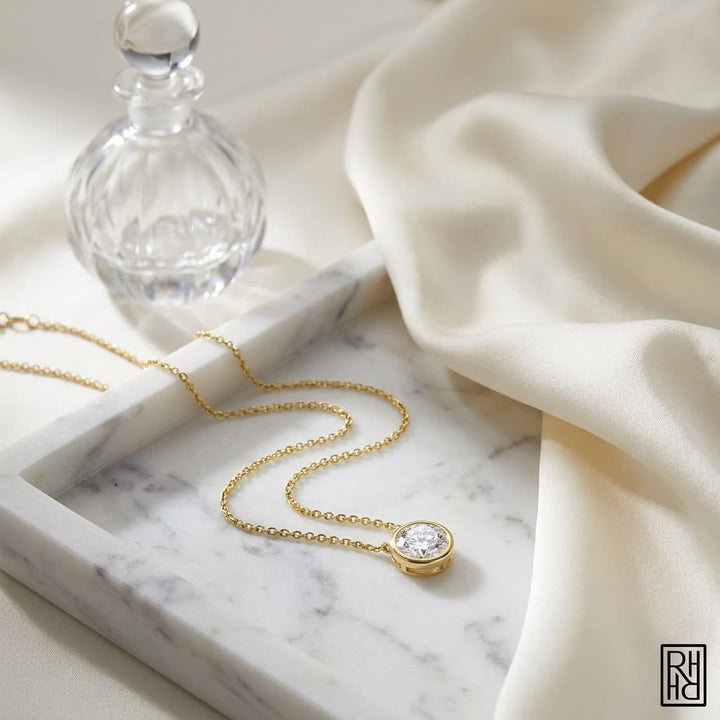 Natural Diamond Round Brilliant Solitaire Pendant in 14K Yellow Gold, 2 ct. t.w., on marble vanity tray with silk