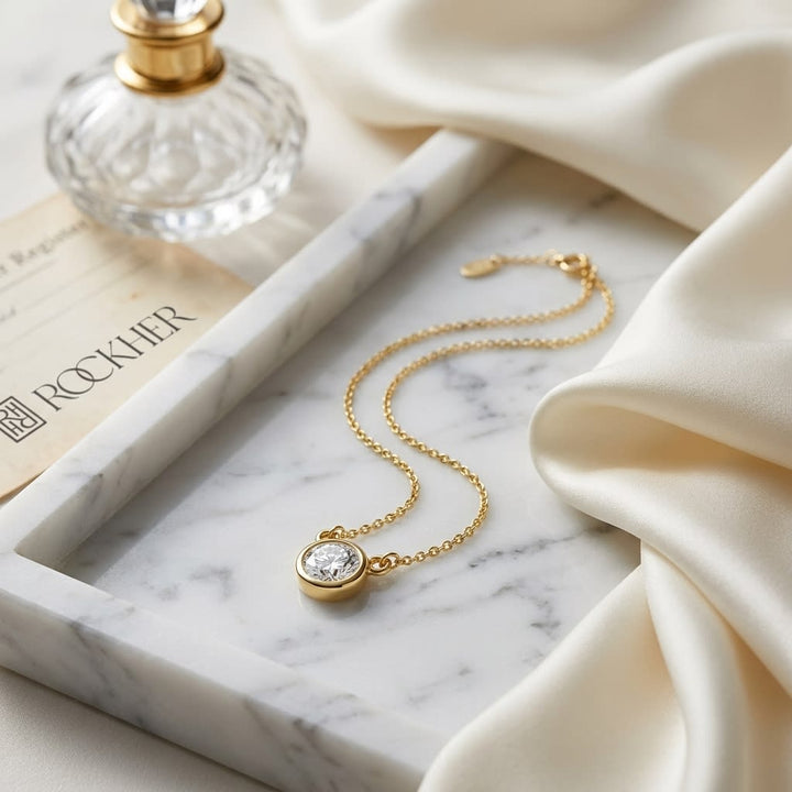 Natural Diamond Round Brilliant Solitaire Pendant in 14K Yellow Gold, 2 ct. t.w., on marble vanity tray with silk