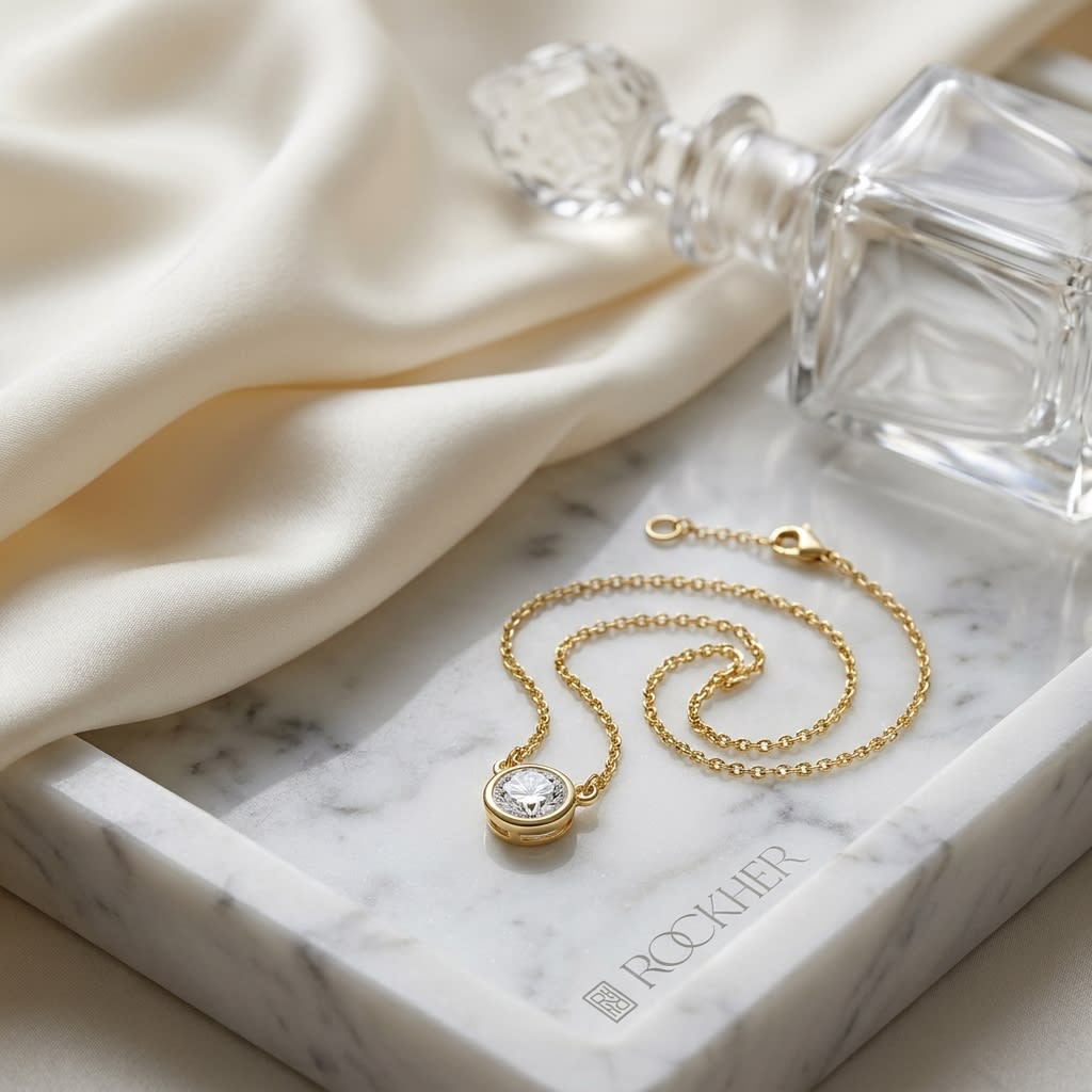 Natural Diamond Round Brilliant Solitaire Pendant in 14K Yellow Gold, 1 ct. t.w., on marble vanity tray with silk