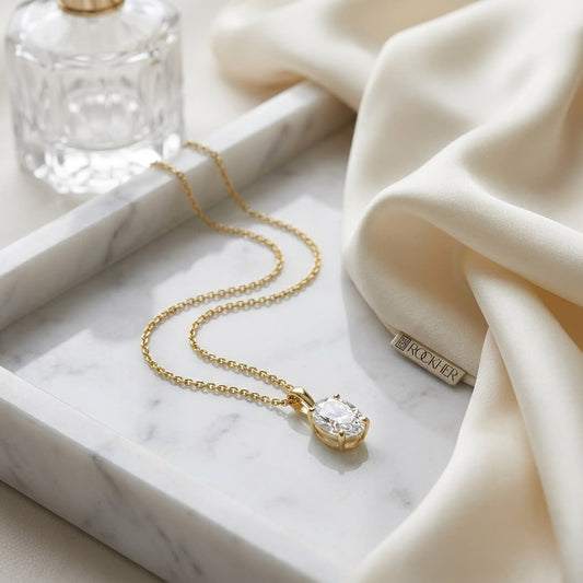 Natural Diamond Oval Solitaire Pendant in 14K Yellow Gold, 4 ct. t.w., on marble vanity tray with silk