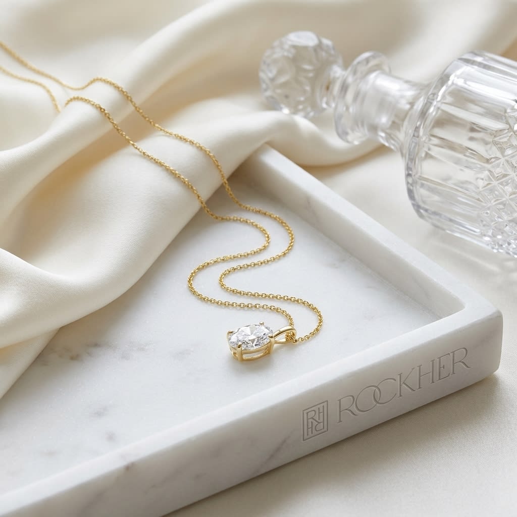 Natural Diamond Oval Solitaire Pendant in 14K Yellow Gold, 2 ct. t.w., on marble vanity tray with silk
