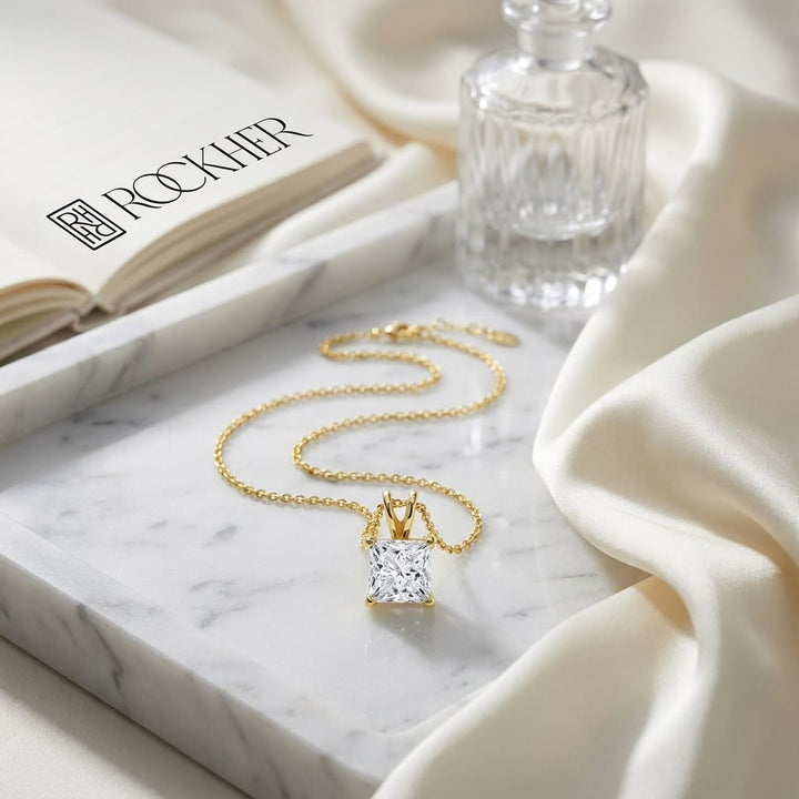 Natural Diamond Princess Cut Solitaire Pendant in 14K Yellow Gold, 2 ct. t.w., on marble vanity tray with silk