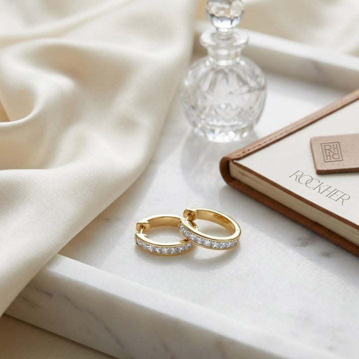 Diamond Princess Cut Channel Hinged Hoop Earrings in 14K Yellow Gold, on marble vanity tray with silk
