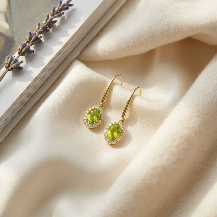 Peridot & Diamond Oval Halo Leverback Earrings 1/4ctw in 14K Yellow Gold - flat lay