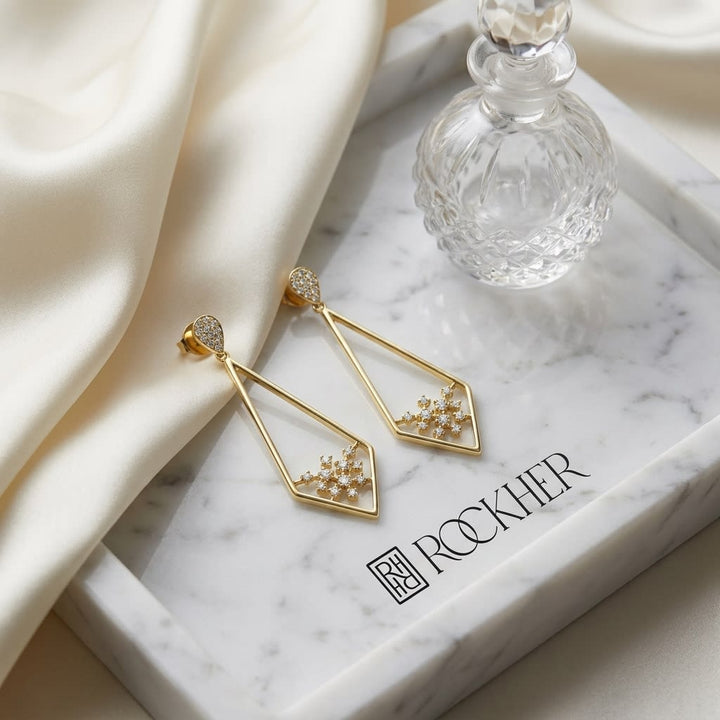 Diamond Pave Elongated Diamond Shaped Earrings in 14K Yellow Gold, on marble vanity tray with silk