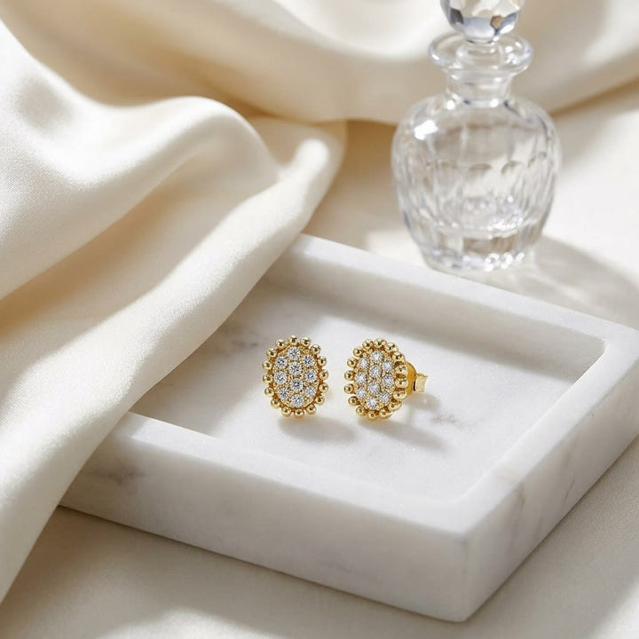 Natural Diamond Oval Stud Earrings in 14K Yellow Gold, on marble vanity tray with silk