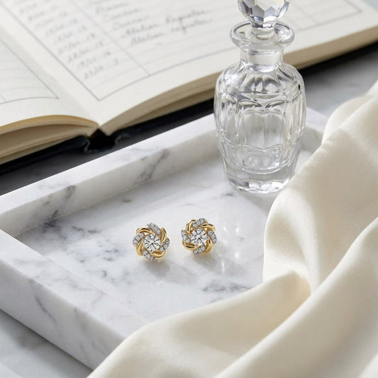 Natural Diamond Round Brilliant Stud Earrings in 14K Yellow Gold, on marble vanity tray with silk