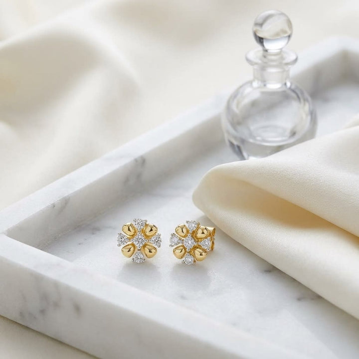Natural Diamond Round Brilliant Stud Earrings in 14K Yellow Gold, on marble vanity tray with silk