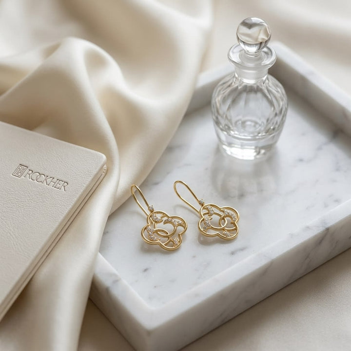 Diamond Open Clover Dangle Earrings With Twine Design And French Wire Backs in 14K Yellow Gold, on marble vanity tray with silk