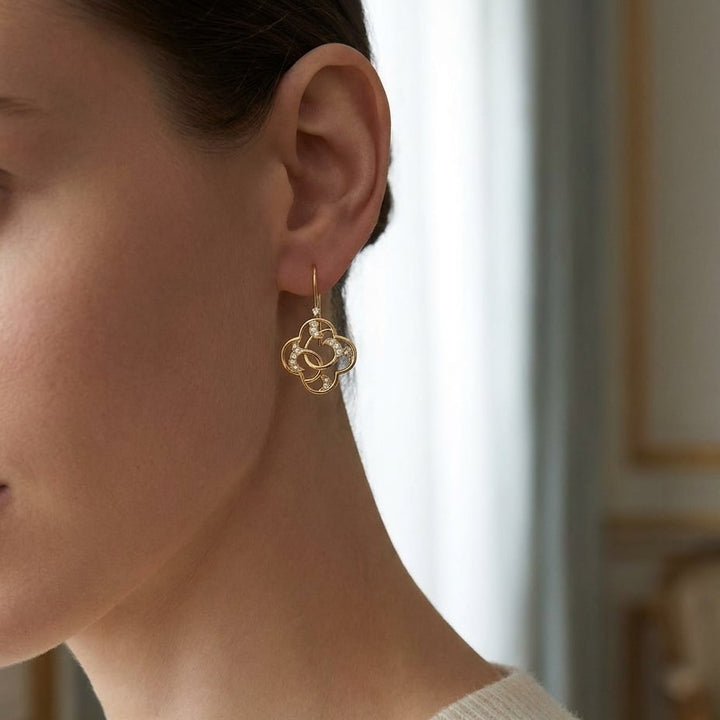 Diamond Open Clover Dangle Earrings With Twine Design And French Wire Backs in 14K Yellow Gold, worn close-up portrait