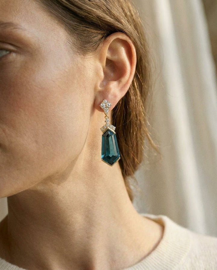 London Blue Topaz and Diamond Shield Drop Earrings in 14k Yellow Gold 0.27ctw, worn close-up portrait