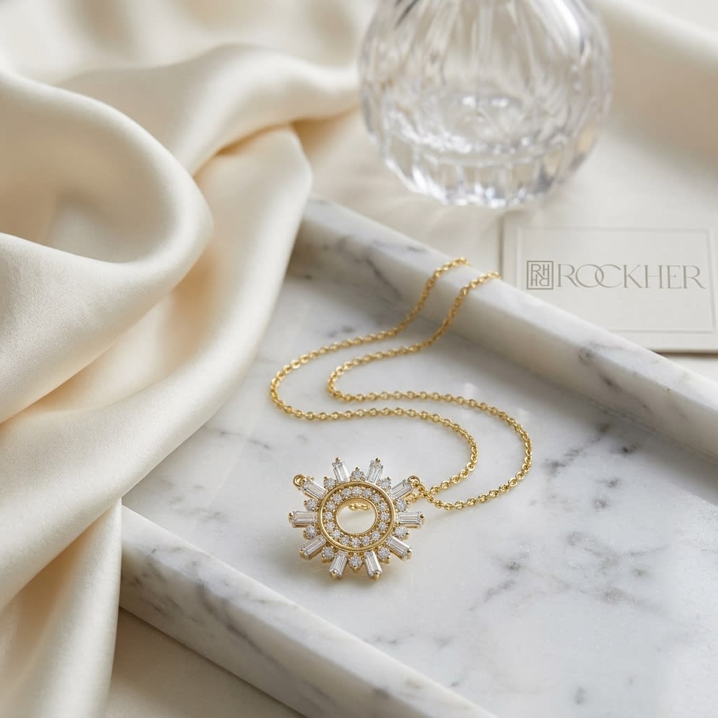 Diamond Round And Straight Baguette Starburst Necklace in 14K Yellow Gold, on marble vanity tray with silk