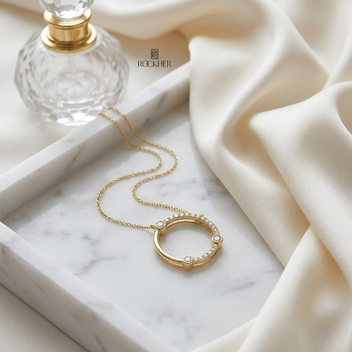 Diamond Circle Necklace With Bezel And High Polish Accent in 14K Yellow Gold, on marble vanity tray with silk