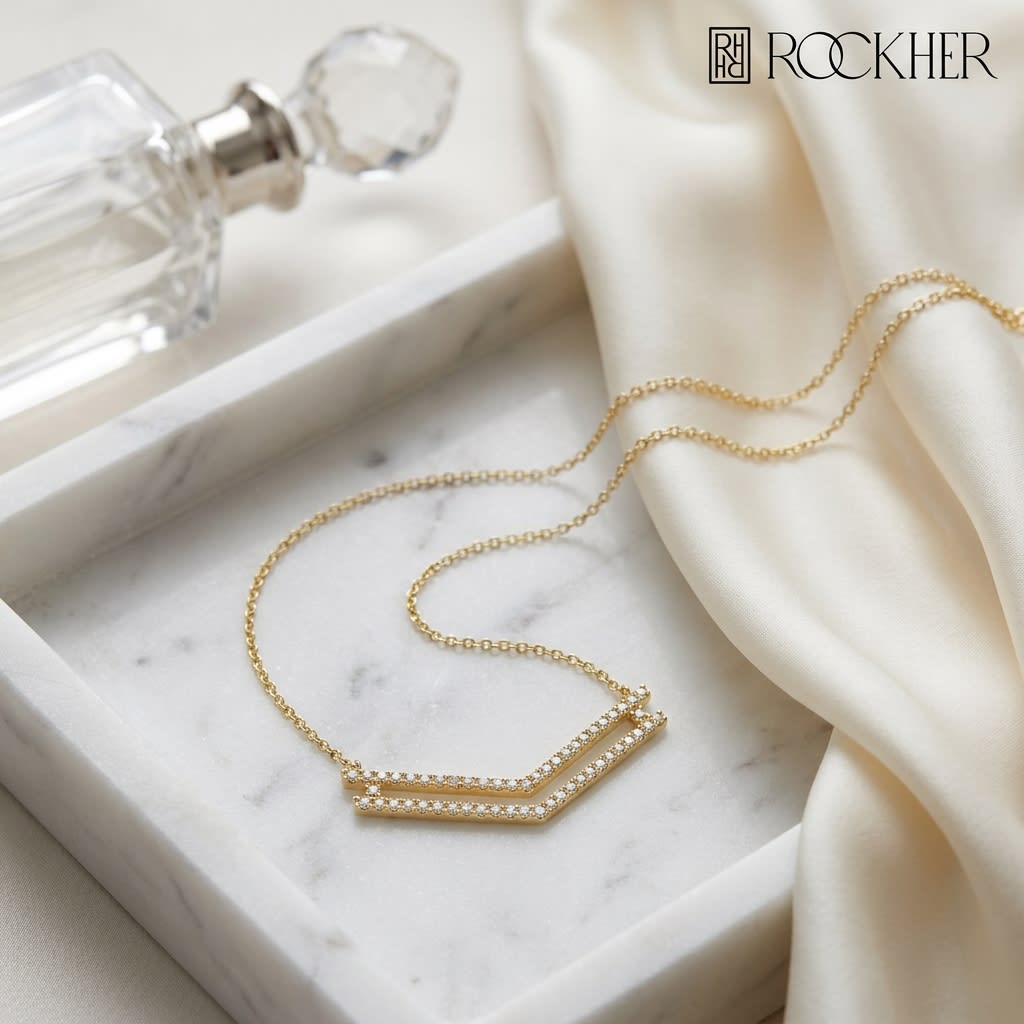Diamond Micro-prong Set Double Chevron Necklace in 14K Yellow Gold, on marble vanity tray with silk