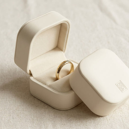 2.5mm Slightly Domed Traditional Oval Wedding Band in 14K Yellow Gold, in navy velvet jewelry box