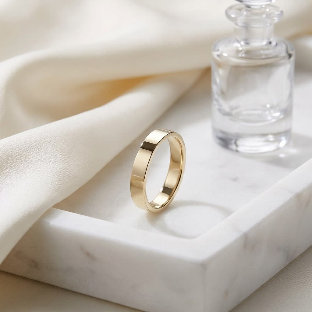 3mm Traditional Flat Wedding Band in 14K Yellow Gold, on marble vanity tray with silk