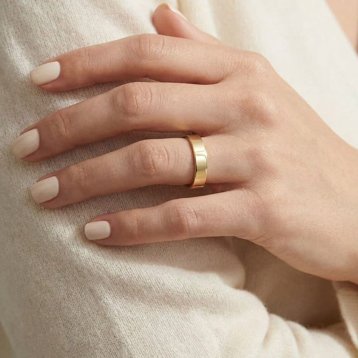 4mm Traditional Flat Wedding Band in 14K Yellow Gold, worn on hand, close-up