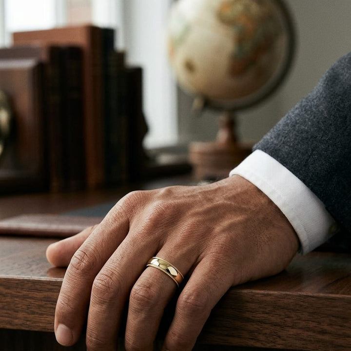 6mm Slightly Domed Traditional Oval Milgrain Wedding Band in 14K Yellow Gold, worn on hand, masculine full view