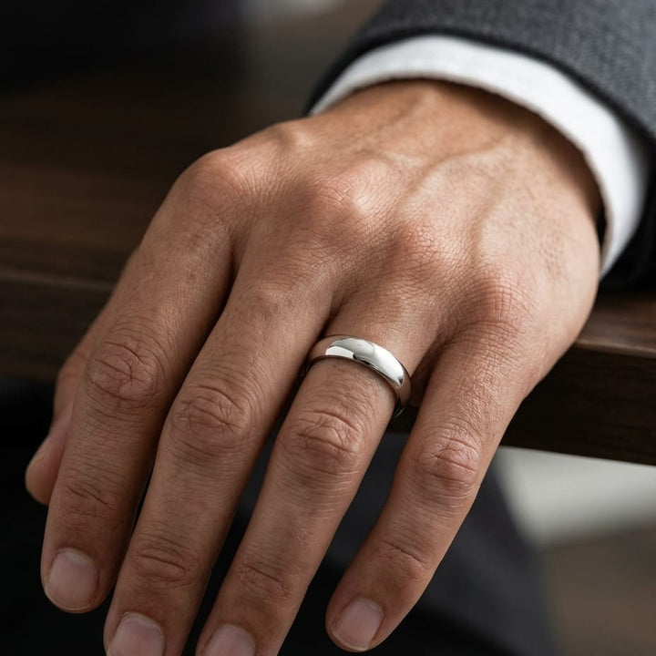 4.5mm Deluxe Comfort-Fit Wedding Band in 14K Yellow Gold, worn on hand, masculine close-up