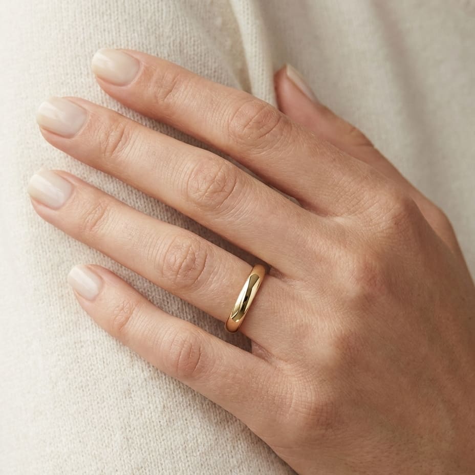 3mm High Dome Comfort-Fit Wedding Band in 14K Yellow Gold, worn on hand, close-up