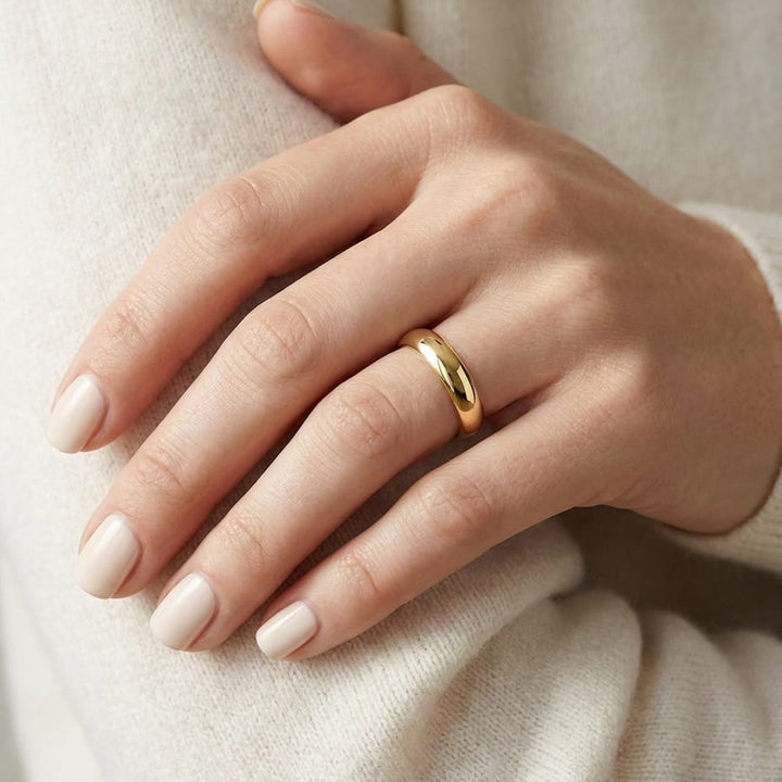 4mm High Dome Comfort-Fit Wedding Band in 14K Yellow Gold, worn on hand, close-up
