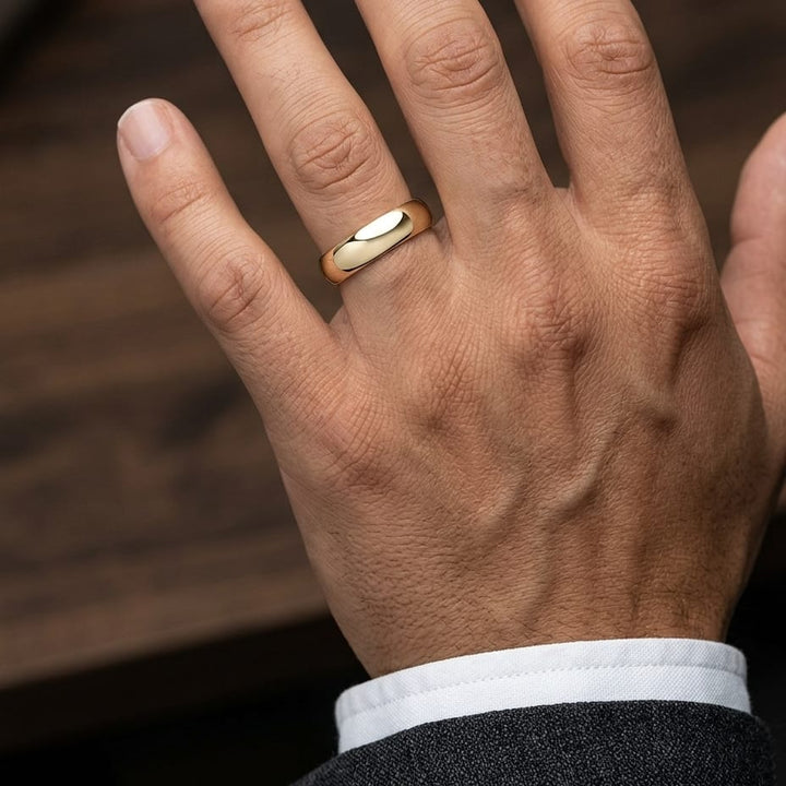 6mm High Dome Comfort-Fit Wedding Band in 14K Yellow Gold, worn on hand, masculine close-up