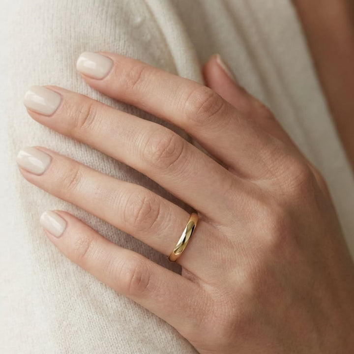 3mm Low Dome Wedding Band in 14K Yellow Gold, worn on hand, close-up