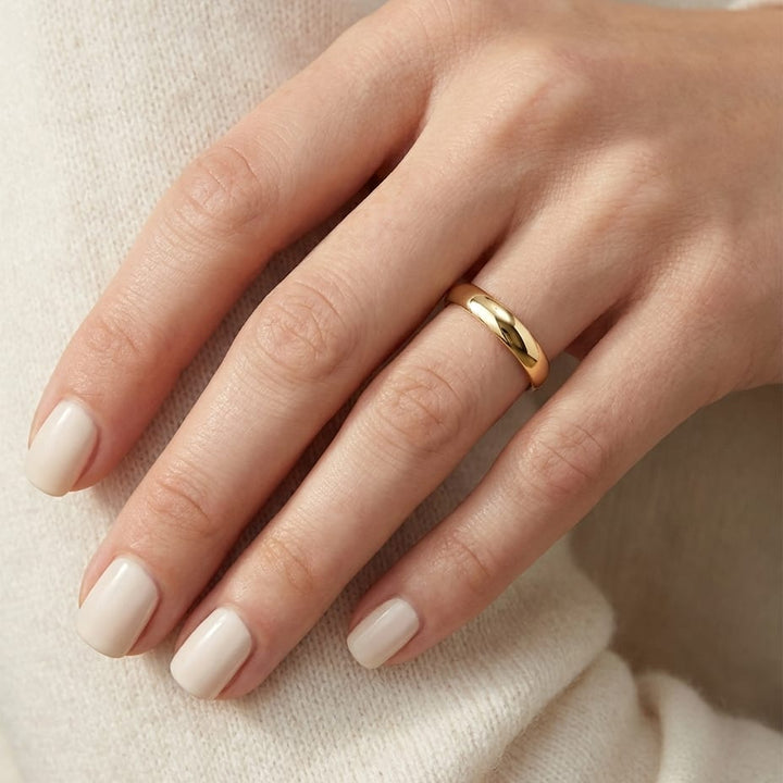 4mm Low Dome Wedding Band in 14K Yellow Gold, worn on hand, close-up