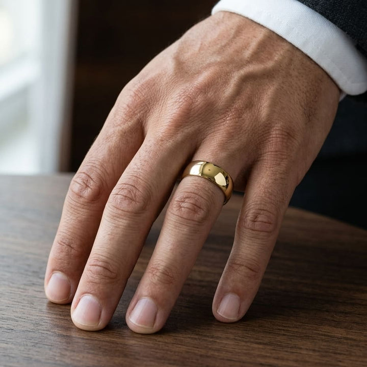 7mm Low Dome Wedding Band in 14K Yellow Gold, worn on hand, masculine close-up