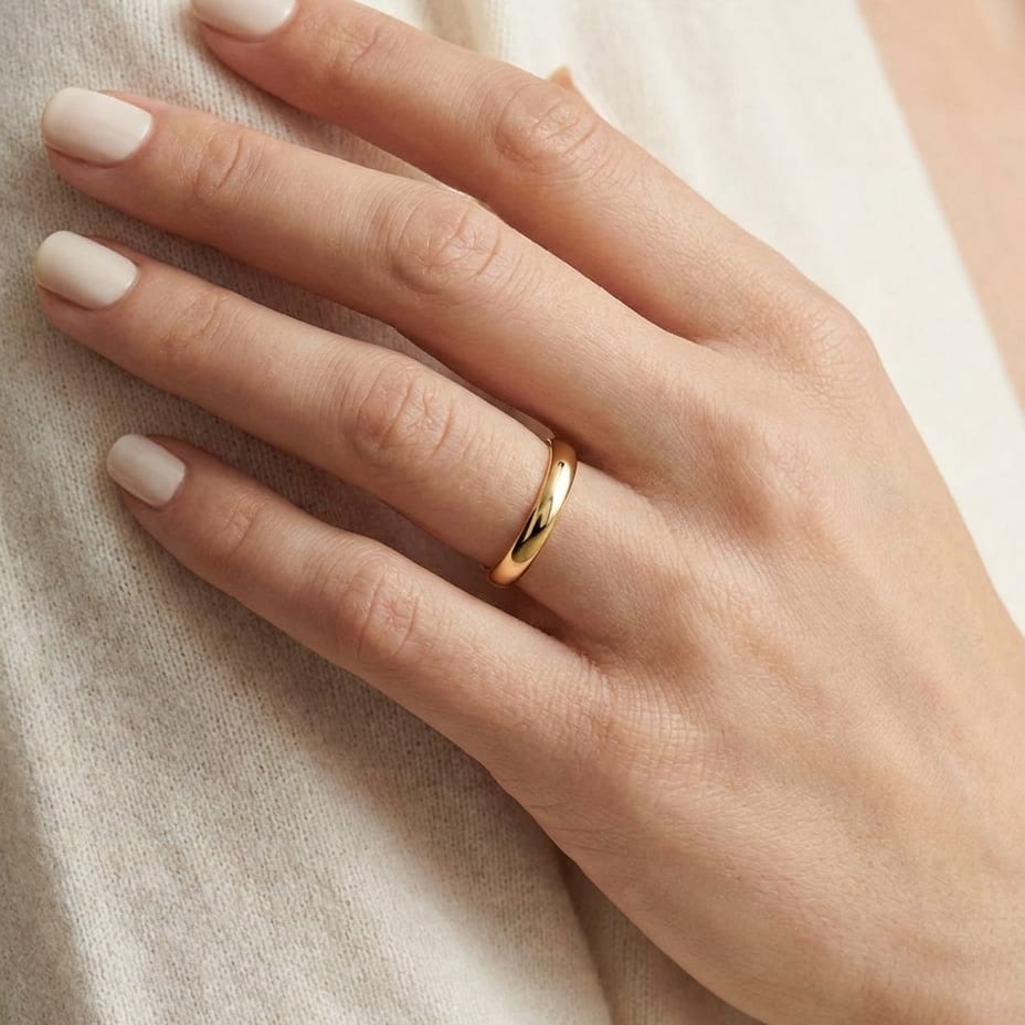 2mm Slightly Domed Comfort-Fit Wedding Band in 14K Yellow Gold, worn on hand, close-up