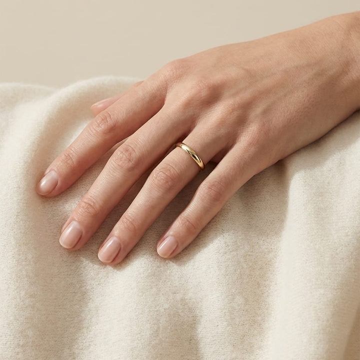 2.5mm Slightly Domed Comfort-Fit Wedding Band in 14K Yellow Gold, worn on hand, full view