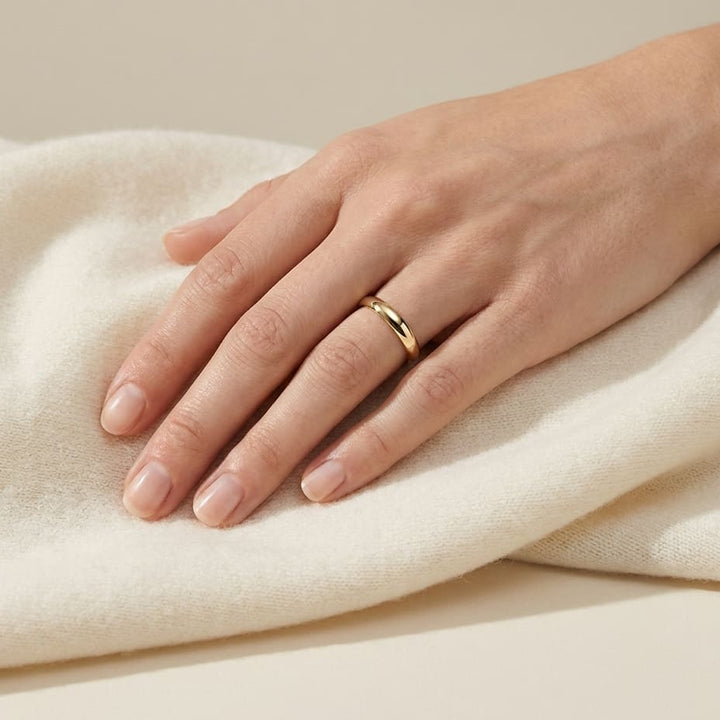 3mm Slightly Domed Comfort-Fit Wedding Band in 14K Yellow Gold, worn on hand, full view