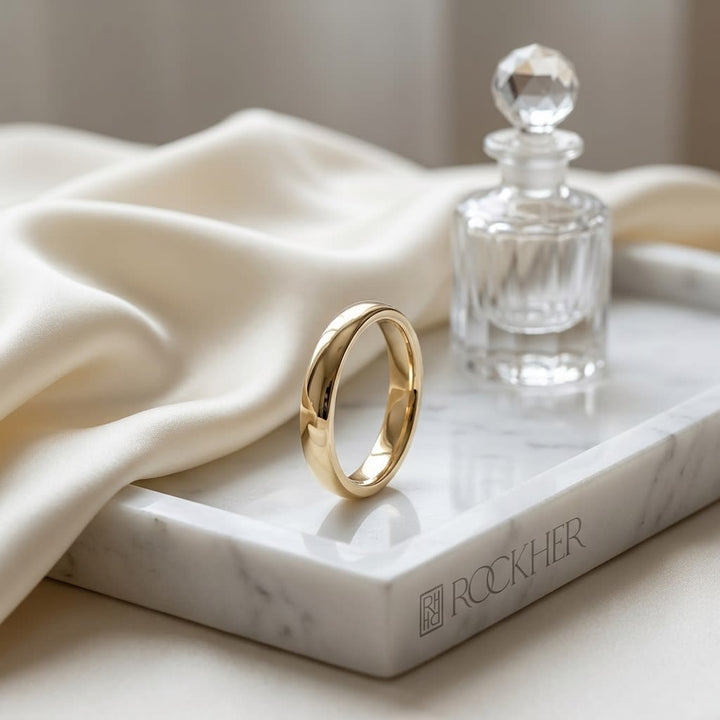 3mm Slightly Domed Comfort-Fit Wedding Band in 14K Yellow Gold, on marble vanity tray with silk