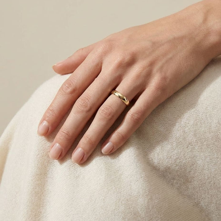 4mm Slightly Domed Comfort-Fit Wedding Band in 14K Yellow Gold, worn on hand, full view