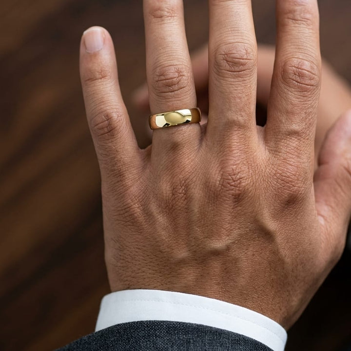 6mm Slightly Domed Comfort-Fit Wedding Band in 14K Yellow Gold, worn on hand, masculine close-up